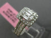 ESTATE LARGE .66CT ROUND & BAGUETTE DIAMOND 18KT WHITE GOLD HALO ENGAGEMENT RING