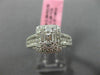 ESTATE LARGE .66CT ROUND & BAGUETTE DIAMOND 18KT WHITE GOLD HALO ENGAGEMENT RING