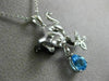 ESTATE .77CT DIAMOND & BLUE TOPAZ 14KT WHITE & BLACK GOLD PANTHER FLOWER PENDANT