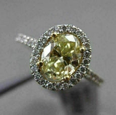 ESTATE 1.32CT GIA FANCY YELLOW DIAMOND 18KT WHITE GOLD OVAL HALO ENGAGEMENT RING