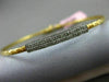 ESTATE .15CT DIAMOND 14KT TWO TONE GOLD ELONGATED PAVE FLEXIBLE BANGLE BRACELET
