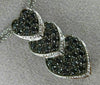 ESTATE .78CT WHITE & BLACK DIAMOND 14KT WHITE GOLD TRIPLE HEART JOURNEY PENDANT