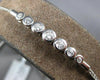 .34CT DIAMOND 18K WHITE GOLD 7 STONE BEZEL GRADUATING ADJUSTABLE TENNIS BRACELET