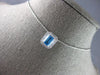 1.34CT DIAMOND & AAA BLUE TOPAZ 14KT WHITE GOLD EMERALD CUT & ROUND HALO PENDANT