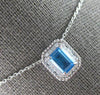 1.34CT DIAMOND & AAA BLUE TOPAZ 14KT WHITE GOLD EMERALD CUT & ROUND HALO PENDANT