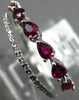 .91CT DIAMOND & AAA RUBY 18KT WHITE GOLD PEAR SHAPE & ROUND CRISS CROSS RING