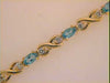 3.81CT DIAMOND & AAA BLUE TOPAZ 14KT YELLOW GOLD OVAL & ROUND XO TENNIS BRACELET