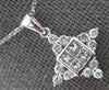 ESTATE .61CT DIAMOND 18KT WHITE GOLD ROUND & PRINCESS SNOWFLAKE FLOATING PENDANT