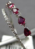 .91CT DIAMOND & AAA RUBY 18KT WHITE GOLD PEAR SHAPE & ROUND CRISS CROSS RING