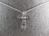 SMALL .52CT DIAMOND 14KT WHITE GOLD 3D ROUND & BAGUETTE CROSS FLOATING PENDANT
