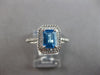 1.44CT DIAMOND & AAA BLUE TOPAZ 14KT WHITE GOLD 3D EMERALD CUT & ROUND HALO RING