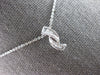 .16CT DIAMOND 14KT WHITE GOLD ROUND & BAGUETTE CRISS CROSS FUN FLOATING PENDANT