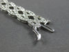 WIDE 4.20CT DIAMOND 14KT WHITE GOLD ROUND CRISS CROSS INFINITY TENNIS BRACELET