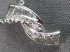 .16CT DIAMOND 14KT WHITE GOLD ROUND & BAGUETTE CRISS CROSS FUN FLOATING PENDANT