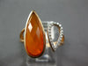 .09CT DIAMOND & AAA ORANGE AGATE 14KT ROSE GOLD PEAR SHAPE CRISS CROSS FUN RING