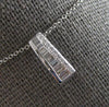 ESTATE .20CT DIAMOND 14KT WHITE GOLD 3D ROUND & BAGUETTE BAR FUN FOATING PENDANT