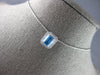 1.34CT DIAMOND & AAA BLUE TOPAZ 14KT WHITE GOLD EMERALD CUT & ROUND HALO PENDANT