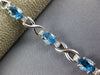 LONG 5.05CT DIAMOND & AAA BLUE TOPAZ 14KT WHITE GOLD OVAL X LOVE TENNIS BRACELET