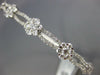 ESTATE WIDE 1.24CT DIAMOND 18KT WHITE GOLD ROUND INFINITY FLOWER BANGLE BRACELET