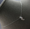 .16CT DIAMOND 14KT WHITE GOLD ROUND & BAGUETTE CRISS CROSS FUN FLOATING PENDANT