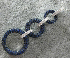 2.16CT DIAMOND & SAPPHIRE 18KT WHITE & BLACK GOLD CIRCULAR JOURNEY LOVE PENDANT