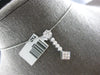 .50CT DIAMOND 14KT WHITE GOLD ROUND & PRINCESS INVISIBLE FLOWER FLOATING PENDANT