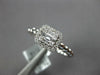 ESTATE .27CT DIAMOND 18KT WHITE GOLD ROUND & BAGUETTE INVISIBLE HALO BEADED RING