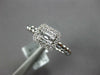 ESTATE .27CT DIAMOND 18KT WHITE GOLD ROUND & BAGUETTE INVISIBLE HALO BEADED RING