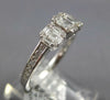 ESTATE .64CT DIAMOND 18KT WHITE GOLD ROUND & BAGUETTE INVISIBLE SQUARE LOVE RING