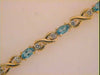 3.81CT DIAMOND & AAA BLUE TOPAZ 14KT YELLOW GOLD OVAL & ROUND XO TENNIS BRACELET