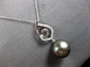 ESTATE LARGE. 15CT DIAMOND & AAA TAHITIAN PEARL 18K WHITE GOLD LOVE KNOT PENDANT
