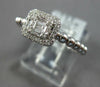 ESTATE .27CT DIAMOND 18KT WHITE GOLD ROUND & BAGUETTE INVISIBLE HALO BEADED RING