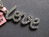 ESTATE .16CT DIAMOND 14KT WHITE GOLD 3D SCRIPT LOVE FLOATING PENDANT