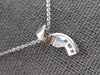 .16CT DIAMOND 14KT WHITE GOLD ROUND & BAGUETTE CRISS CROSS FUN FLOATING PENDANT