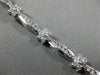ESTATE WIDE 2.66CT DIAMOND 14KT WHITE GOLD ROUND FLOWER CHANNEL TENNIS BRACELET