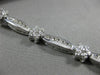 ESTATE WIDE 2.66CT DIAMOND 14KT WHITE GOLD ROUND FLOWER CHANNEL TENNIS BRACELET