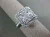 ESTATE LARGE .82CT ROUND & BAGUETTE DIAMOND 18KT WHITE GOLD HALO ENGAGEMENT RING