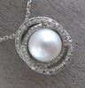 ESTATE .18CT DIAMOND & AAA SOUTH SEA PEARL 14KT WHITE GOLD 3D LOVE KNOT PENDANT