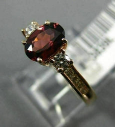 1.40CT ROUND DIAMOND & OVAL RHODOLITE 14KT ROSE GOLD THREE STONE ENGAGEMENT RING