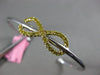 ESTATE .73CT WHITE & FANCY YELLOW DIAMOND 18KT 2 TONE GOLD INFINITY LOVE BANGLE