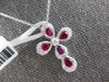 1.17CT DIAMOND & RUBY 18KT WHITE GOLD ROUND & PEAR SHAPE CROSS FLOATING PENDANT