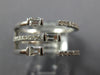WIDE .47CT DIAMOND 18KT WHITE GOLD ROUND & BAGUETTE CRISS CROSS TENSION FUN RING