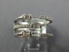 WIDE .47CT DIAMOND 18KT WHITE GOLD ROUND & BAGUETTE CRISS CROSS TENSION FUN RING