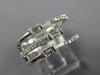 WIDE .47CT DIAMOND 18KT WHITE GOLD ROUND & BAGUETTE CRISS CROSS TENSION FUN RING