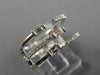 WIDE .47CT DIAMOND 18KT WHITE GOLD ROUND & BAGUETTE CRISS CROSS TENSION FUN RING