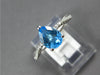 2.07CT DIAMOND & AAA BLUE TOPAZ 18KT WHITE GOLD PEAR SHAPE & ROUND INFINITY RING