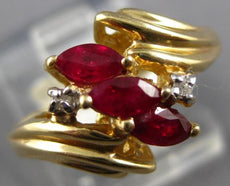 .77CT DIAMOND & AAA RUBY 14KT YELLOW GOLD MARQUISE & ROUND 3 STONE DIAGONAL RING