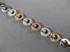 WIDE .97CT WHITE & PINK DIAMOND 18KT WHITE & ROSE GOLD CIRCULAR TENNIS BRACELET