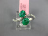 1.33CT DIAMOND & AAA EMERALD 18KT WHITE GOLD OVAL CRISS CROSS INFINITY LOVE RING