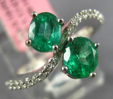 1.33CT DIAMOND & AAA EMERALD 18KT WHITE GOLD OVAL CRISS CROSS INFINITY LOVE RING